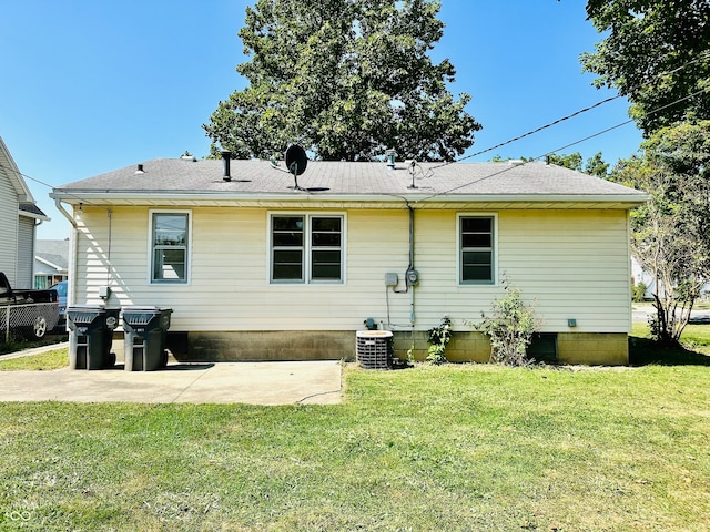 back of property featuring cooling unit, a lawn, and a patio