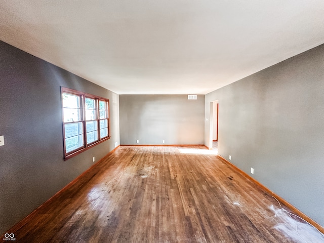 unfurnished room with wood-type flooring