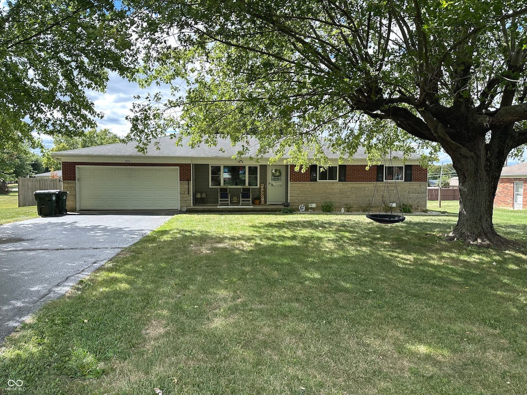 single story home featuring a front lawn and a garage