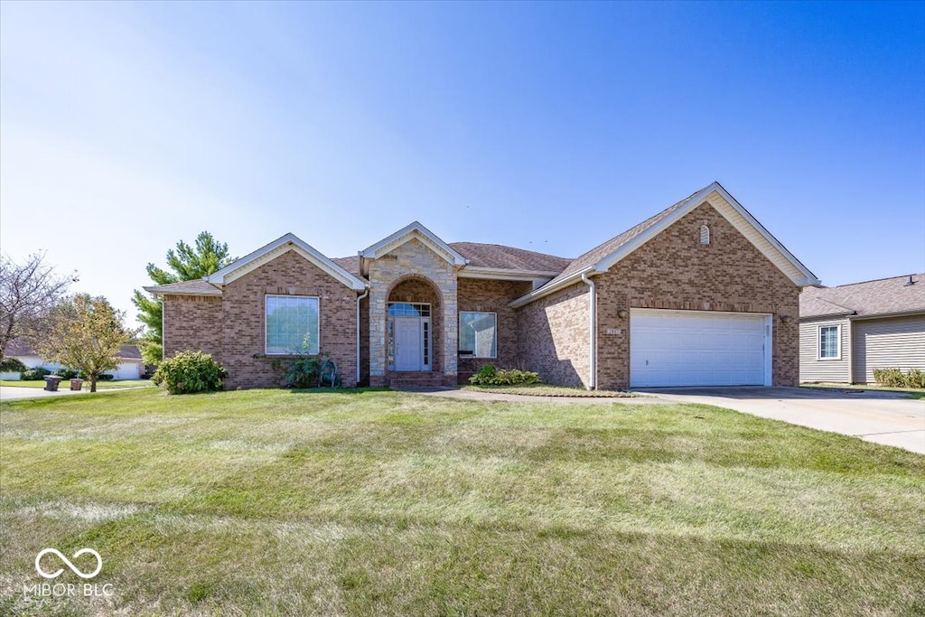 single story home with a garage and a front lawn