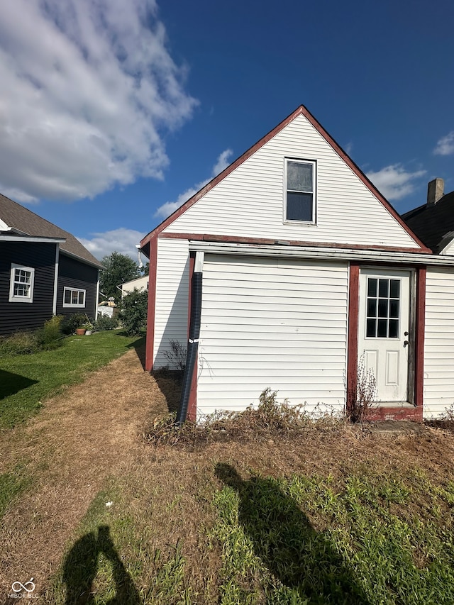 view of property exterior featuring a lawn