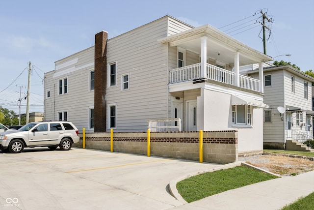 view of side of home with a balcony