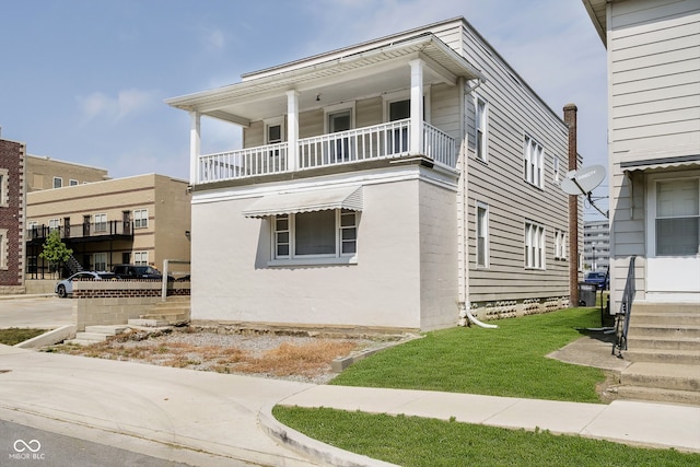 view of front of property with a balcony