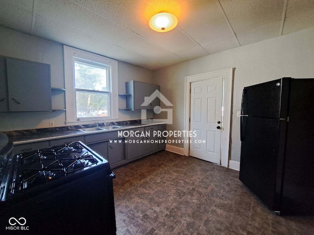 kitchen featuring black appliances, sink, and gray cabinets