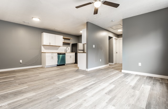 kitchen with light wood-type flooring, white cabinetry, ceiling fan, and appliances with stainless steel finishes