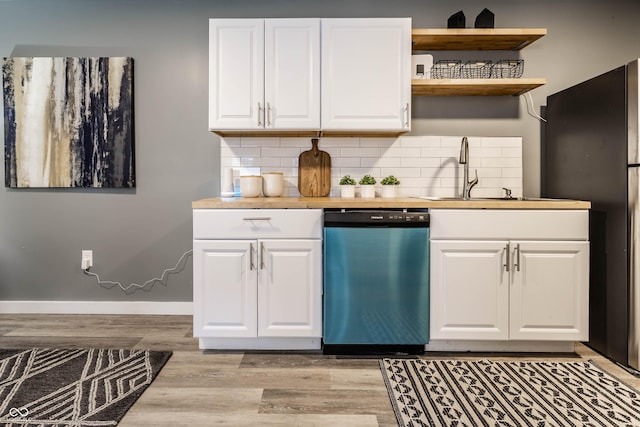 kitchen with dishwasher, tasteful backsplash, light wood-type flooring, and a sink