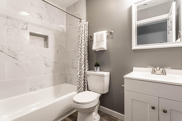 full bathroom with toilet, shower / tub combo, vanity, wood finished floors, and baseboards