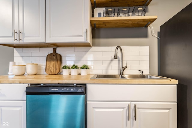 kitchen with dishwasher, backsplash, a sink, and white cabinets