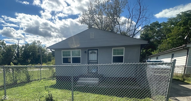 rear view of house featuring a lawn