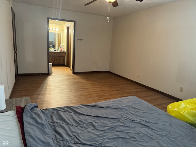 bedroom featuring wood-type flooring, connected bathroom, and ceiling fan