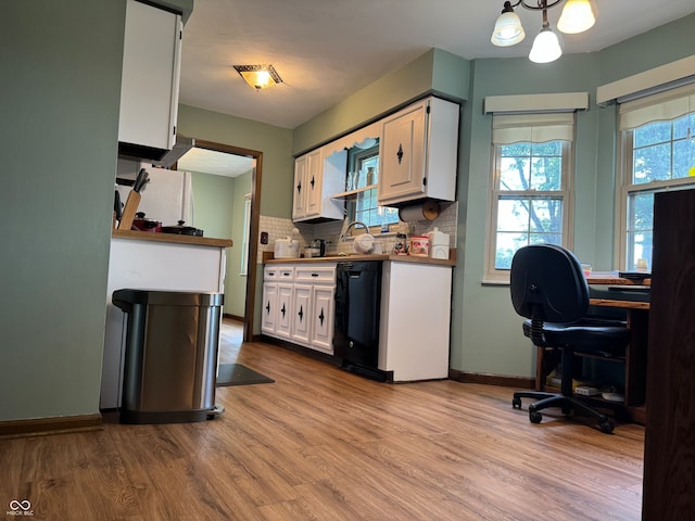 kitchen with plenty of natural light, white cabinets, and light hardwood / wood-style floors