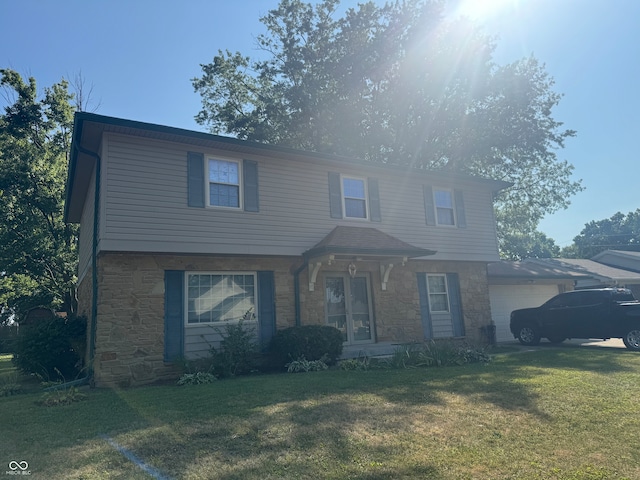 view of front property featuring a garage and a front lawn