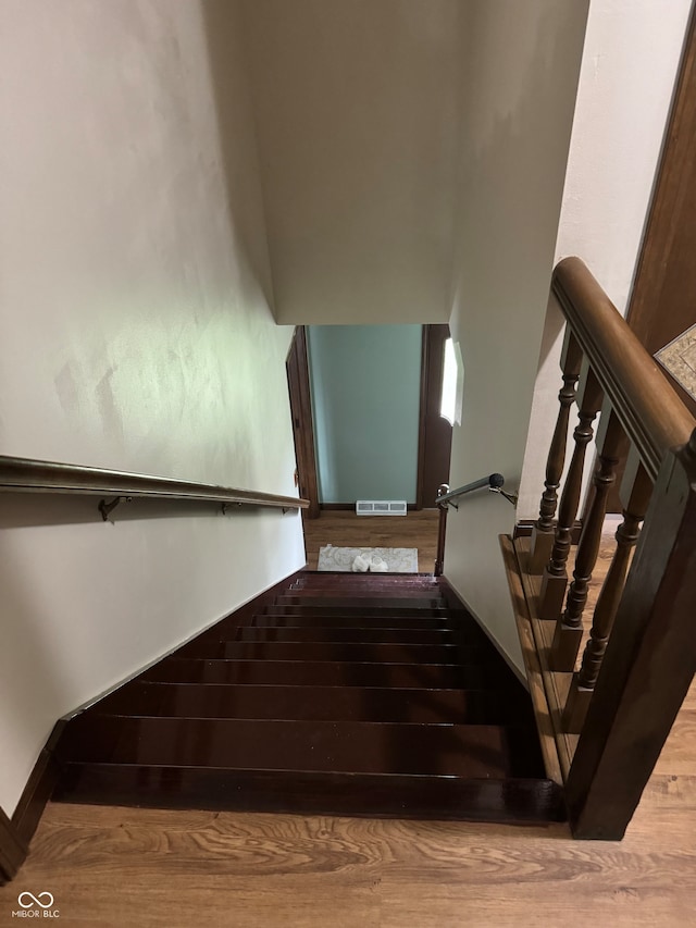 stairway featuring hardwood / wood-style floors