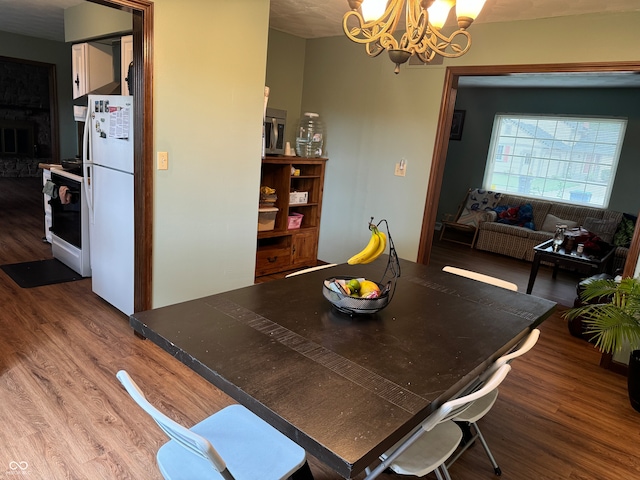 dining space with a notable chandelier and wood-type flooring