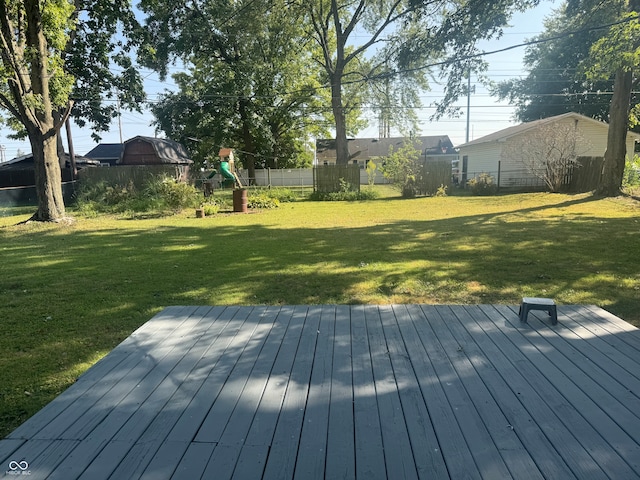 deck featuring a playground and a yard