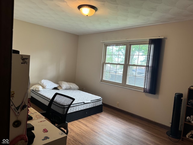 bedroom with hardwood / wood-style flooring