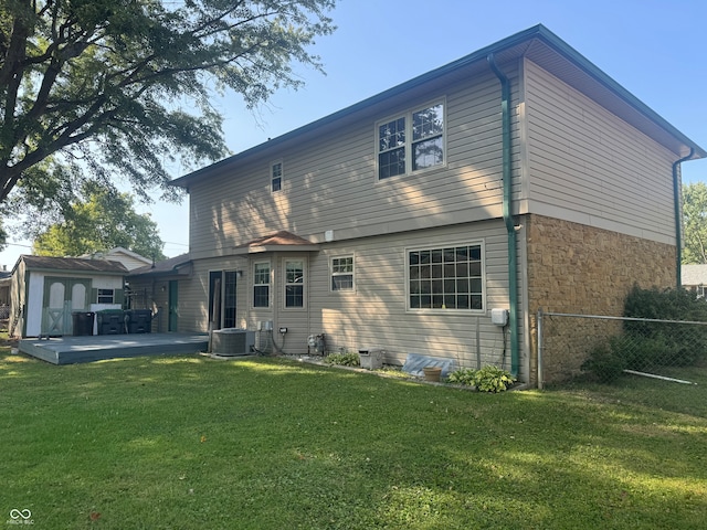 back of property featuring central air condition unit, a yard, and a patio