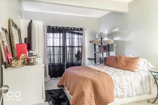 bedroom featuring carpet and beamed ceiling