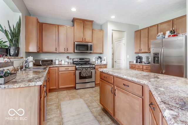 kitchen featuring light tile patterned floors, light stone counters, stainless steel appliances, and sink