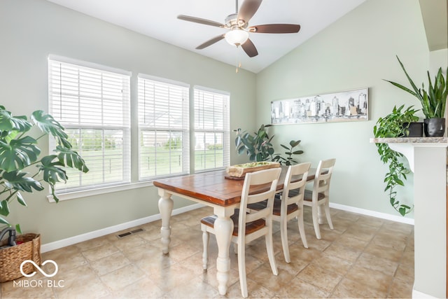 dining space featuring lofted ceiling, light tile patterned floors, and ceiling fan