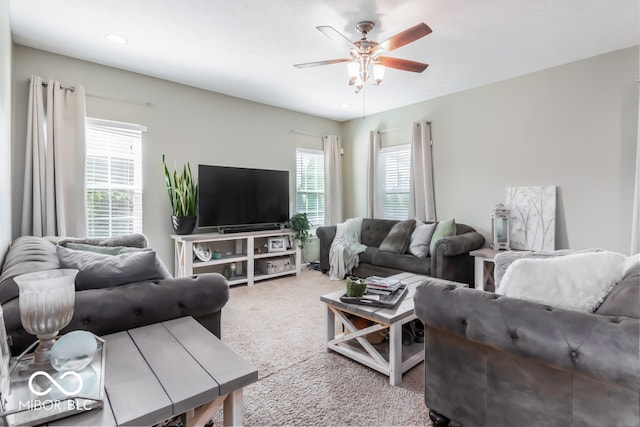 carpeted living room featuring ceiling fan