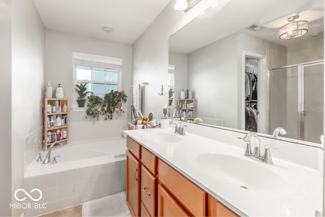 bathroom featuring plus walk in shower, tile patterned floors, and vanity