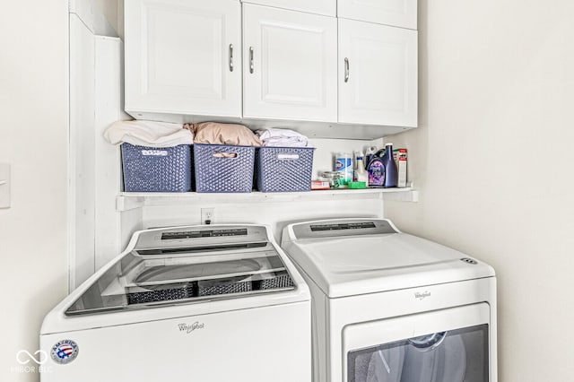 laundry room with cabinet space and washing machine and clothes dryer