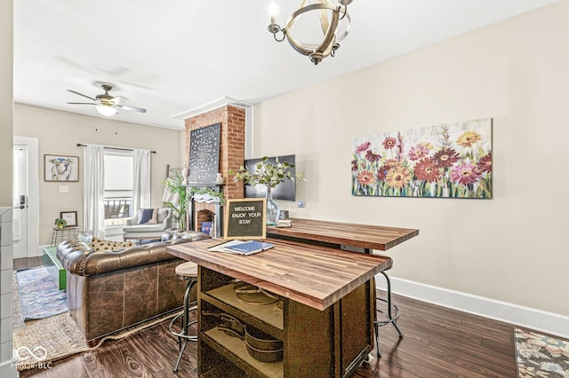 home office with a ceiling fan, dark wood-style flooring, and baseboards