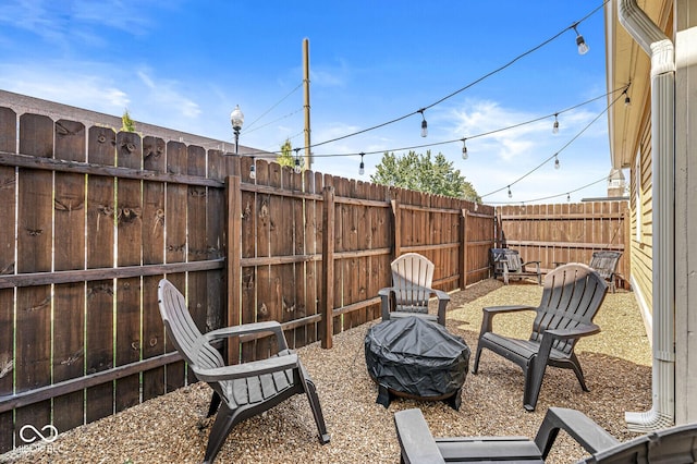 view of patio with a fenced backyard and an outdoor fire pit