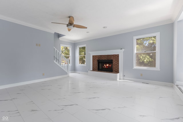 unfurnished living room with a fireplace, ornamental molding, plenty of natural light, and ceiling fan