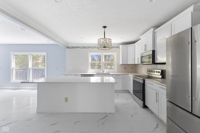 kitchen featuring white cabinets, a wealth of natural light, stainless steel appliances, and a notable chandelier