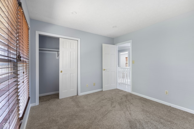 unfurnished bedroom with a closet and carpet