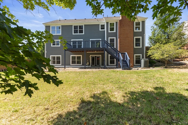 back of house featuring a wooden deck and a lawn