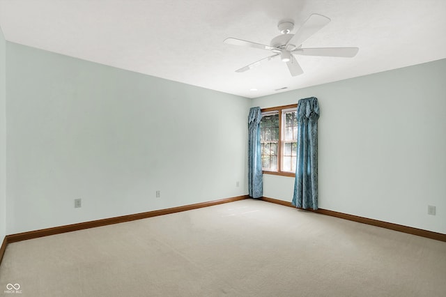 unfurnished room featuring ceiling fan and carpet