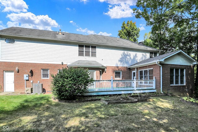 rear view of house with a wooden deck, a lawn, a gazebo, and central AC