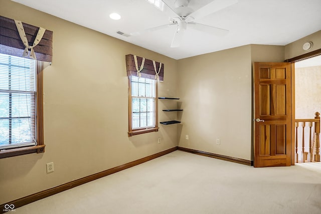 carpeted spare room with ceiling fan