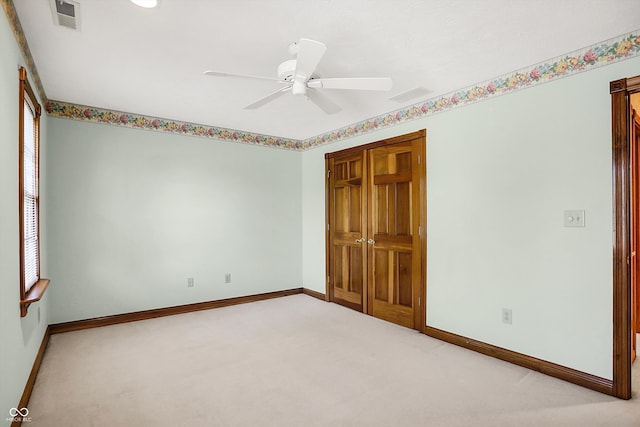 unfurnished bedroom with a closet, ceiling fan, and light carpet