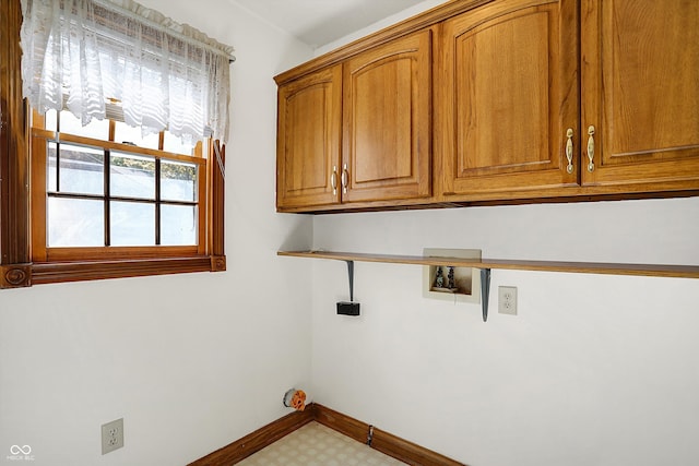 laundry room featuring hookup for a washing machine and cabinets