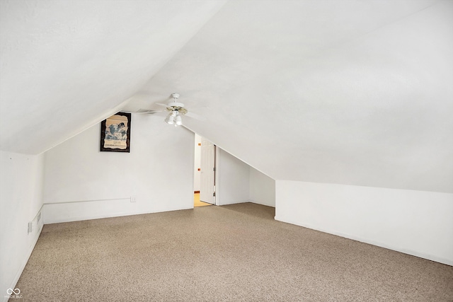 additional living space with ceiling fan, carpet floors, and vaulted ceiling