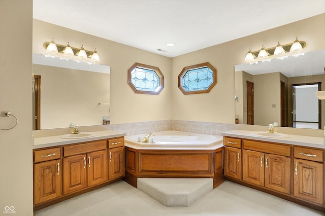 bathroom with a tub to relax in and vanity