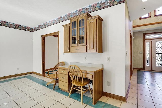 tiled dining area with plenty of natural light and built in desk