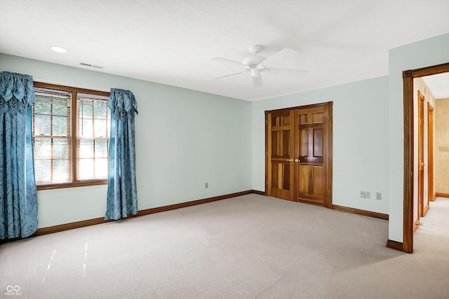 unfurnished bedroom with light carpet and ceiling fan