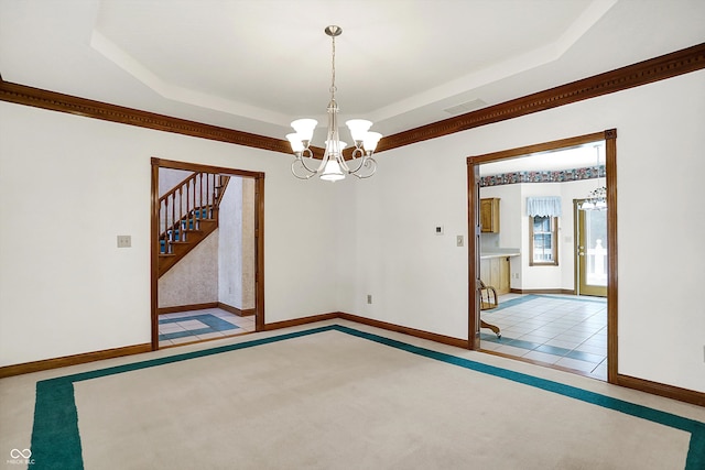 spare room featuring a tray ceiling, light tile patterned floors, and a notable chandelier