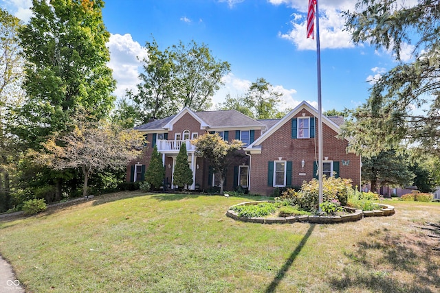 view of front of home with a front lawn and a balcony