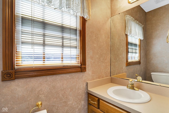 bathroom featuring toilet and vanity