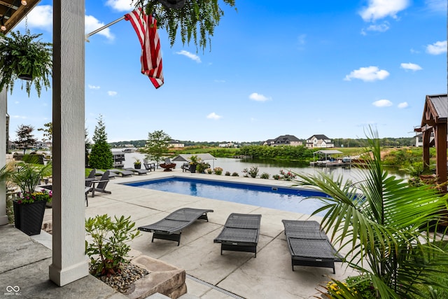 view of swimming pool with a water view and a patio area