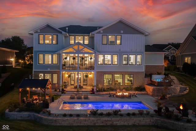 back house at dusk featuring an outdoor living space and a patio area