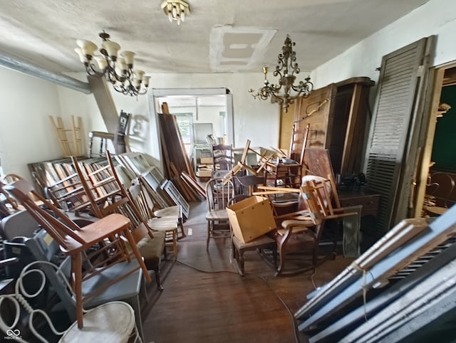 misc room featuring an inviting chandelier and hardwood / wood-style flooring