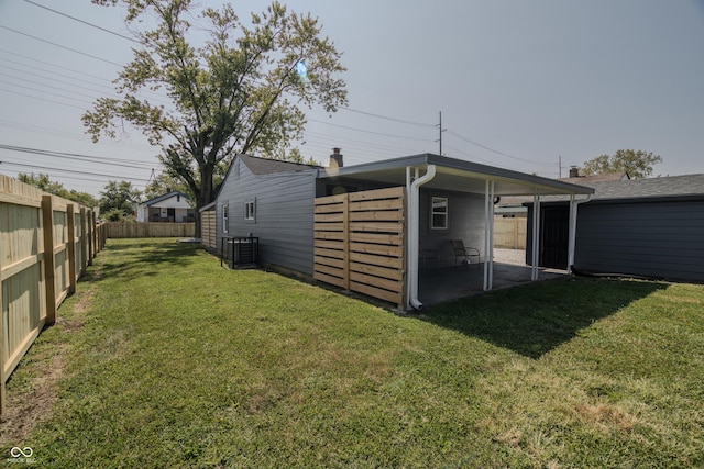 exterior space featuring a carport and a fenced backyard