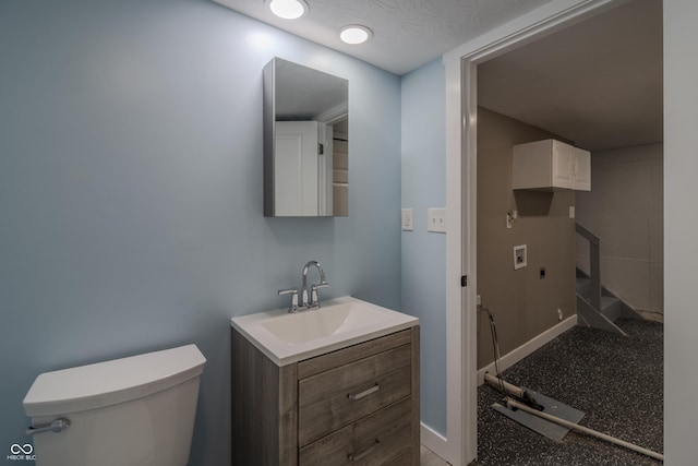 bathroom featuring a textured ceiling, toilet, vanity, and baseboards